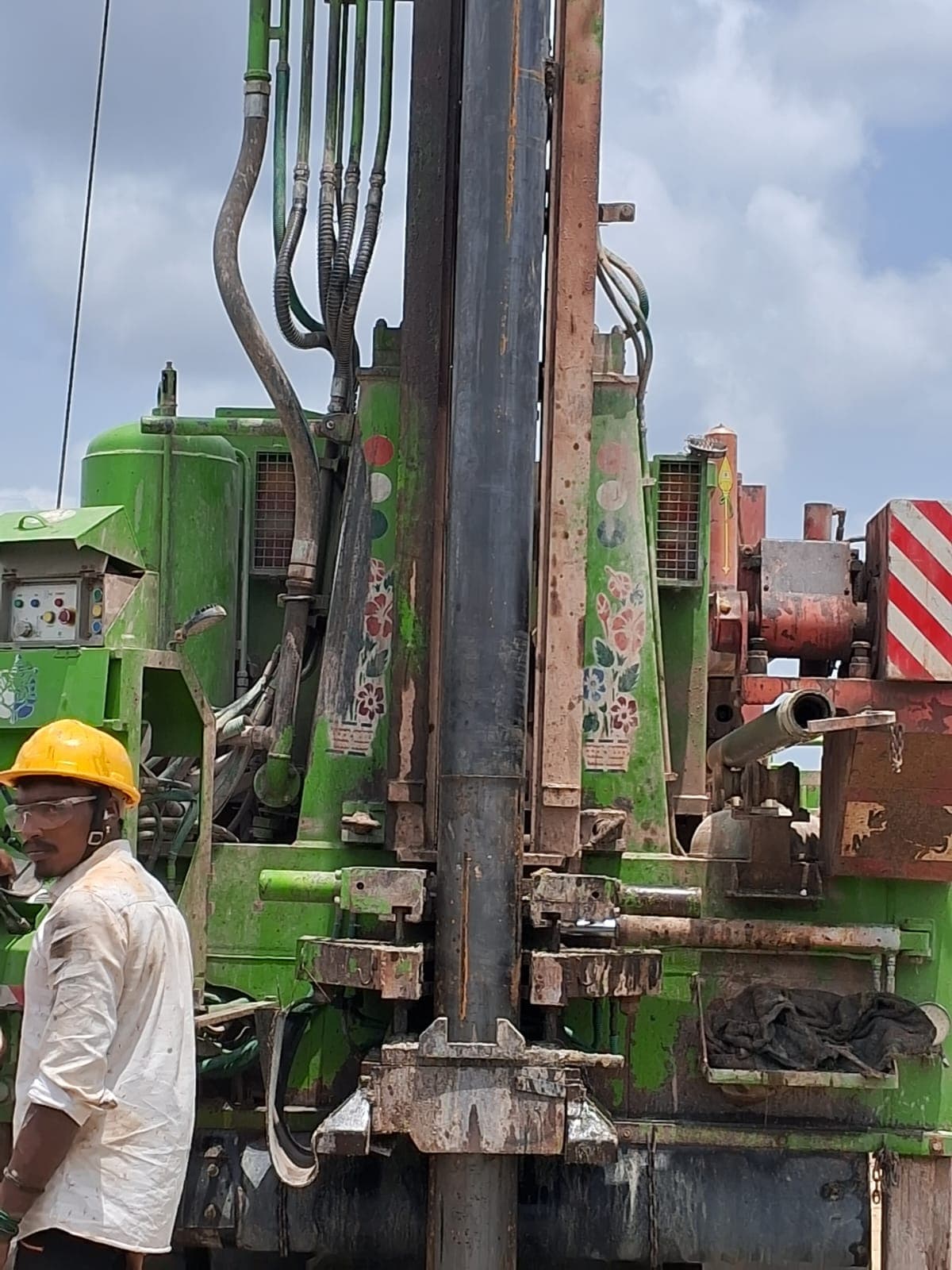 Drilling rig mast during borehole work for MMO anode installation